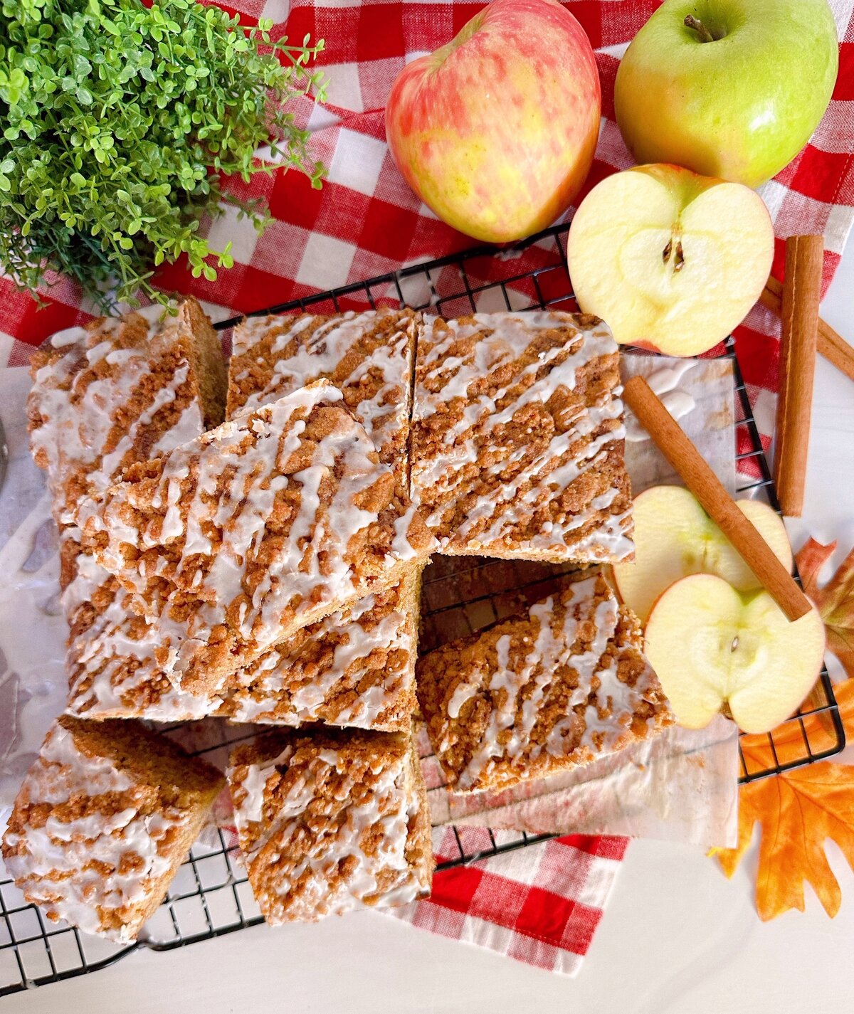 Apple Cider Crumb Cake on a board cut and ready to serve.