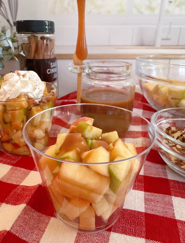Drizzling the caramel sauce over the apples.