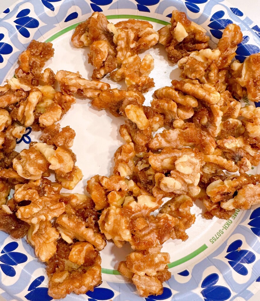 Candied pecans on  a paper plate.