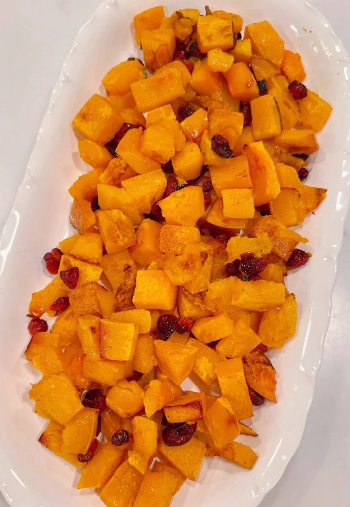 Placing the roasted squash on a platter.