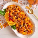 Overhead shot of platter filled with roasted butternut squash with cranberries.