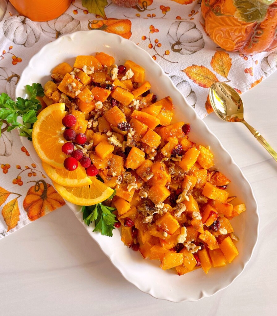 Overhead shot of platter filled with roasted butternut squash with cranberries.