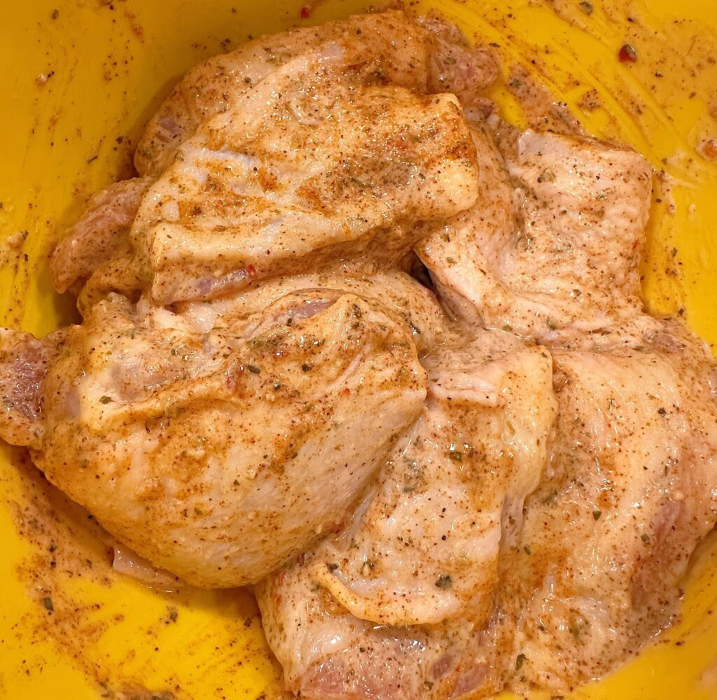Chicken coated with garlic parmesan sauce in the bowl.