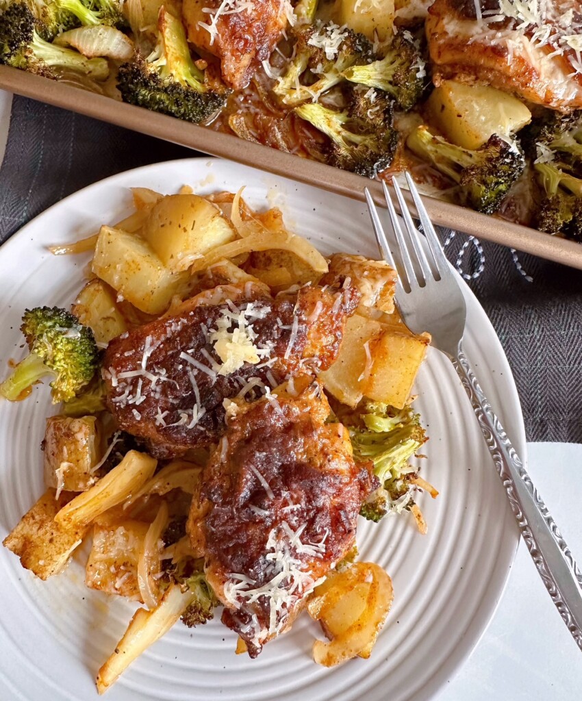 Garlic Parmesan Chicken Sheet Pan dinner on a dinner plate with a fork.