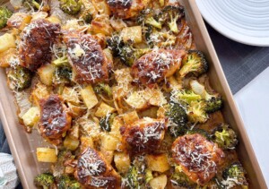 Sheet Pan Garlic Parmesan Chicken Thighs sprinkled with fresh parmesan.