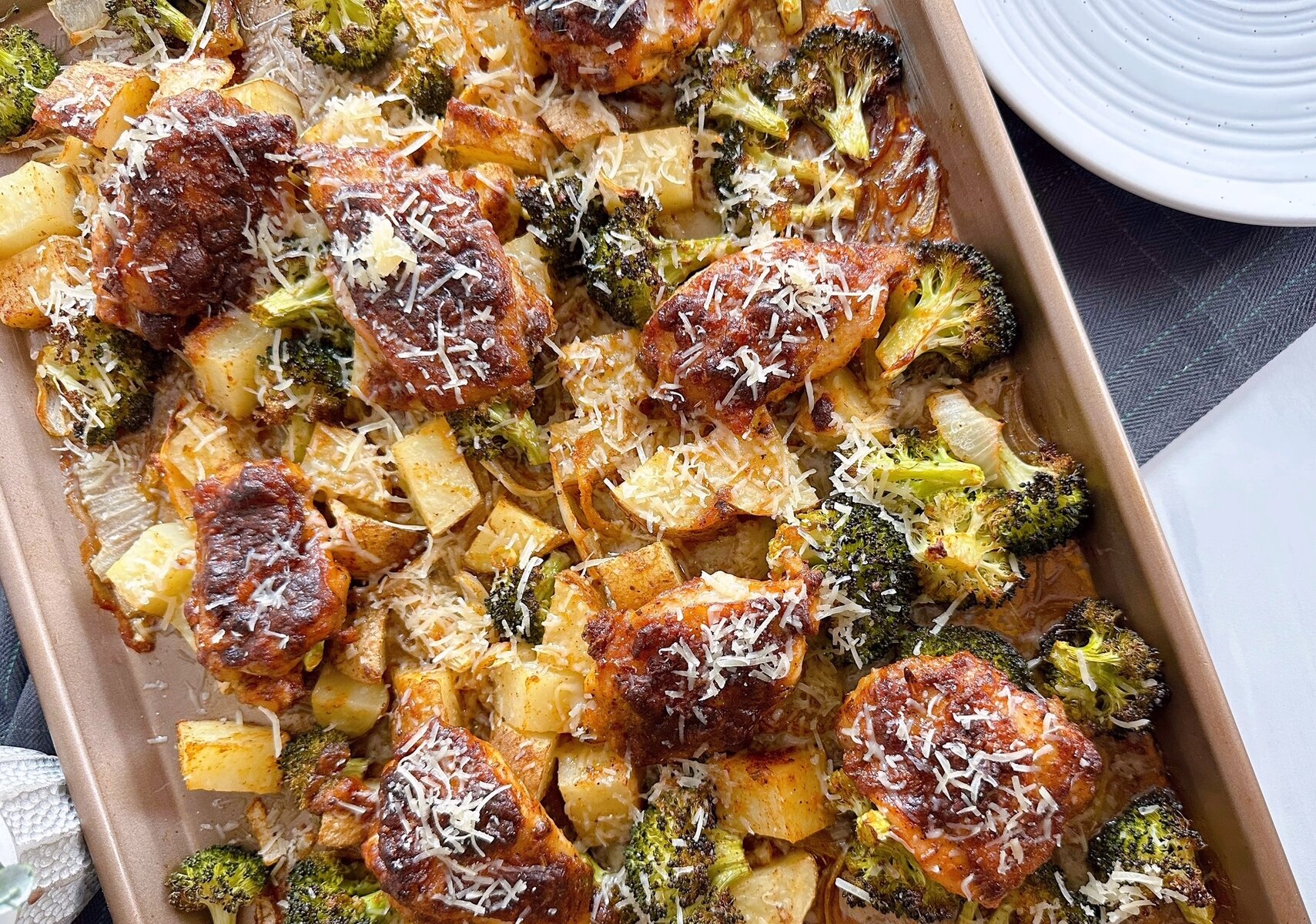 Sheet Pan Garlic Parmesan Chicken Thighs sprinkled with fresh parmesan.