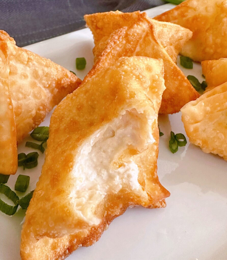 One of the wontons bitten into to show cream filling.