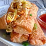 Close-up photo of egg rolls split in half to show filling.