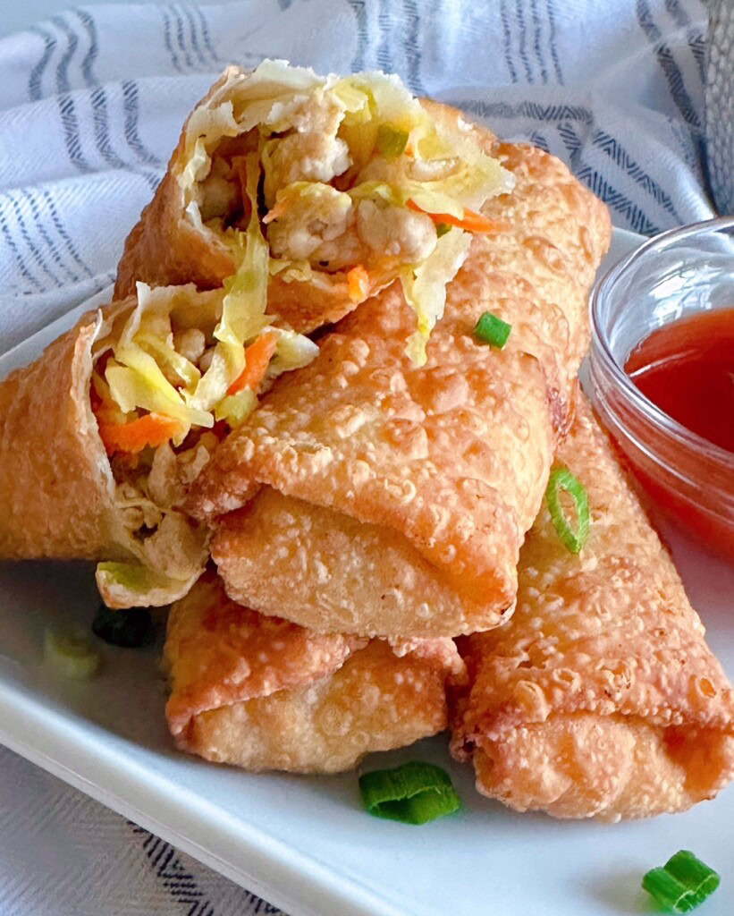 Close-up photo of egg rolls split in half to show filling.