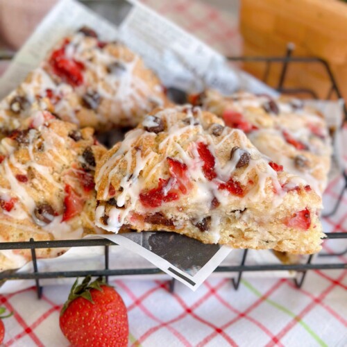 Strawberry Chocolate Chip Scones piled high in a metal basket with a close-up on one scone.