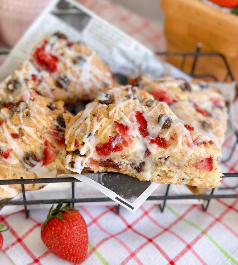 Strawberry Chocolate Chip Scones piled high in a metal basket with a close-up on one scone.