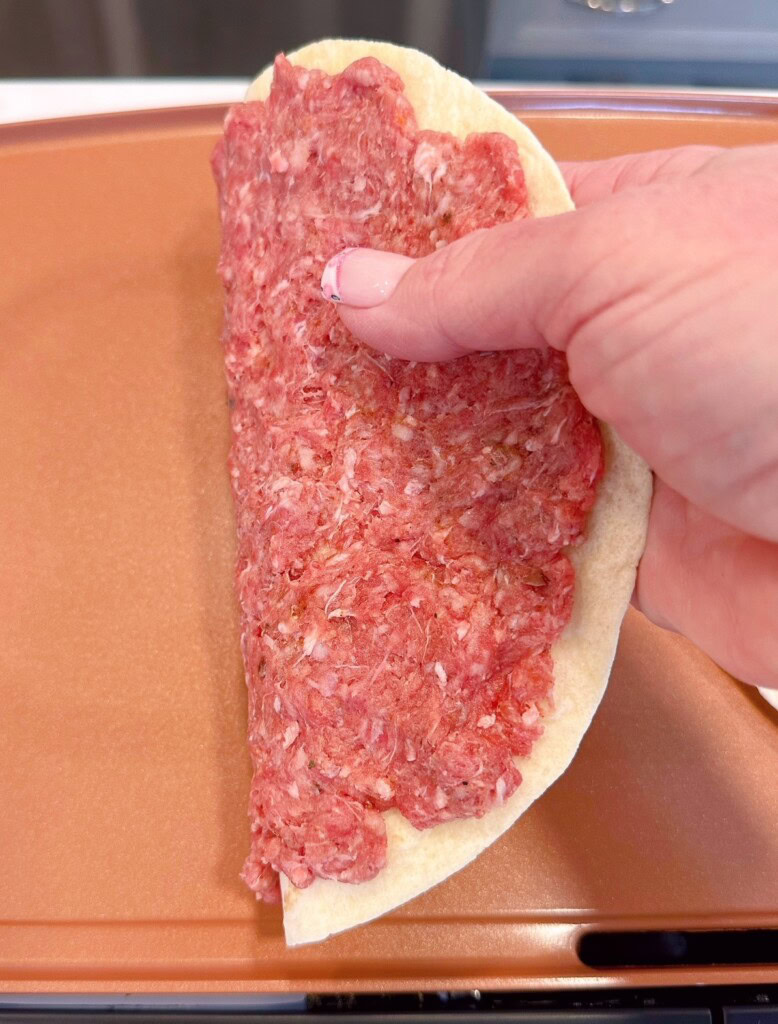 Placing the quesadilla on a preheated griddle.