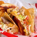 Bacon Cheese Burger Smash Quesadilla's cut into quarters and set in a red basket.