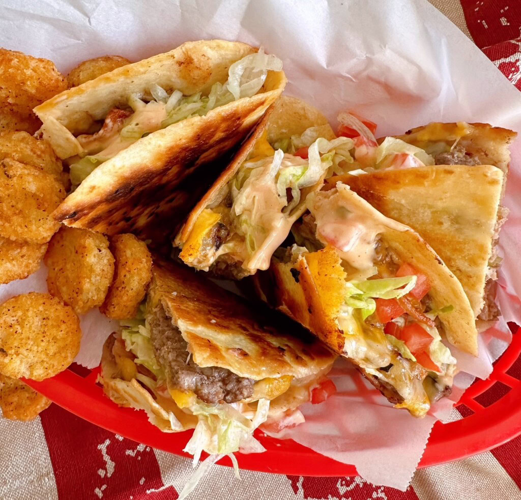 Smash Burger Quesadillas arranged in a basket with tater tots.