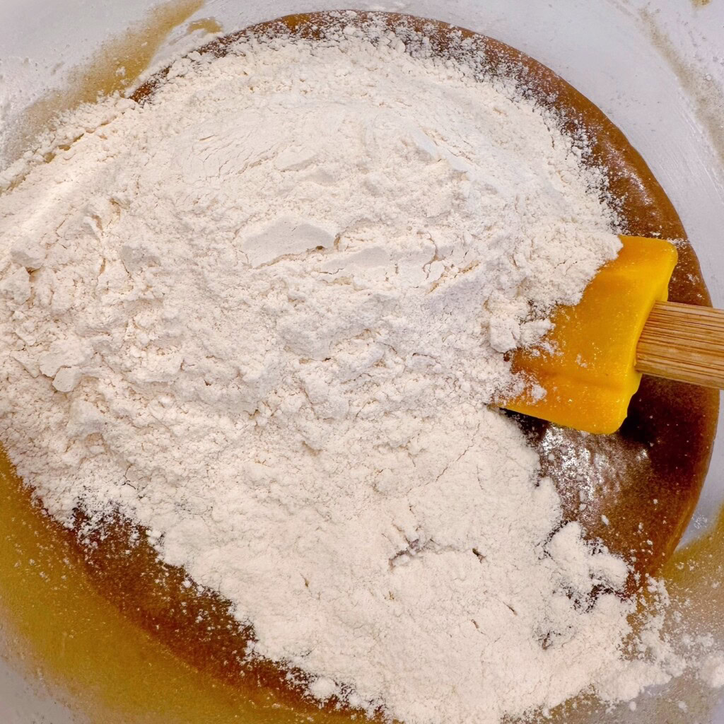 Adding dry ingredients to brown sugar mixture.