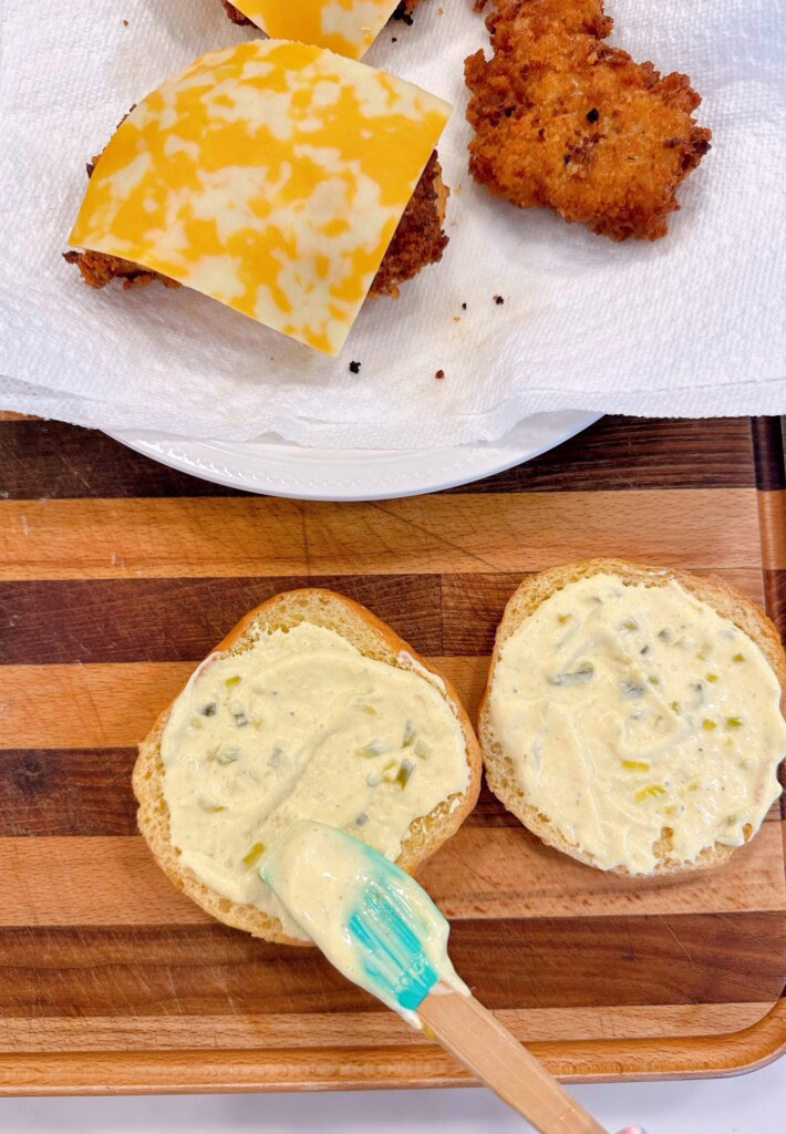 Topping buns with tartar sauce.