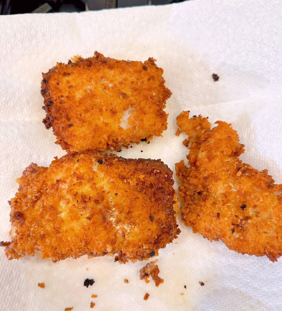 Cooked fish on a paper towel to drain.