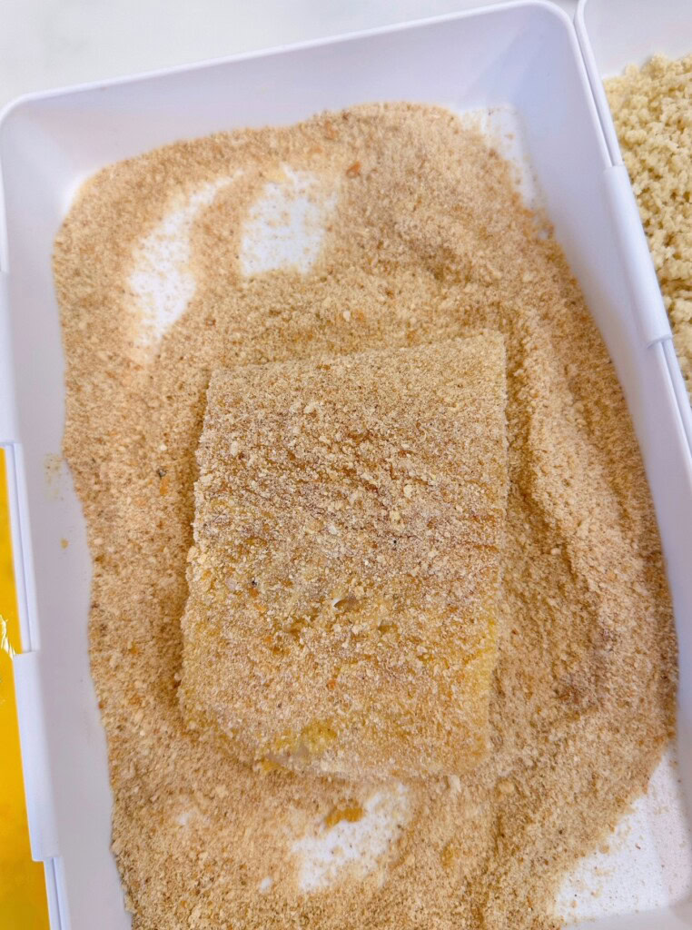 Dredging egg coated fish in plain bread crumbs.