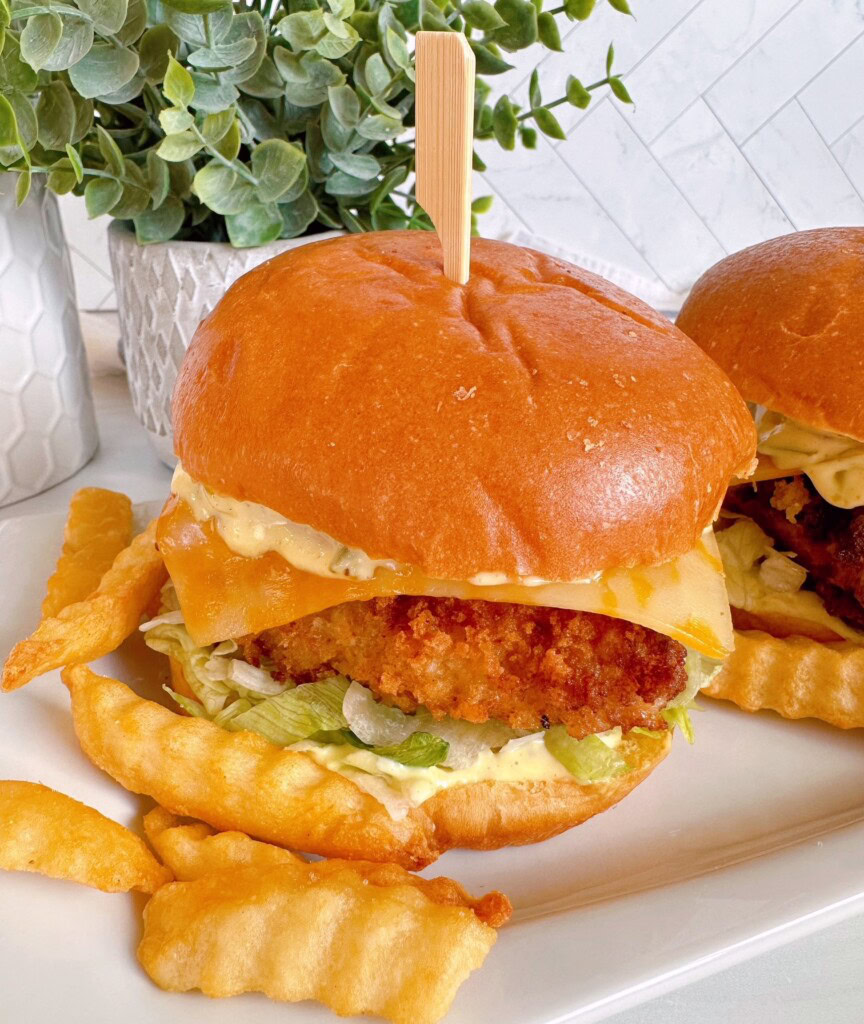 Fish sandwiches up close with tartar sauce.