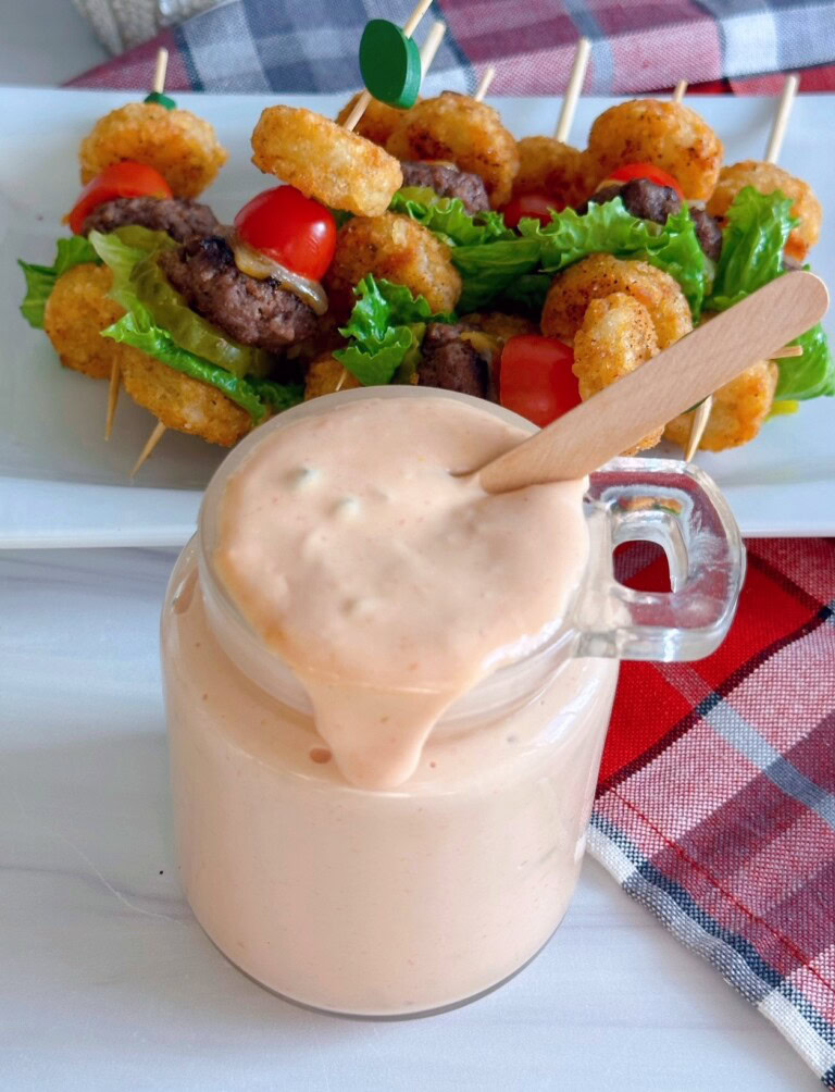 Easy Serect Sauce recipe in a glass jar and dripping slightly down the sides.