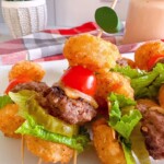 Cheeseburger mini bites on a football skewer upclose ready to serve.