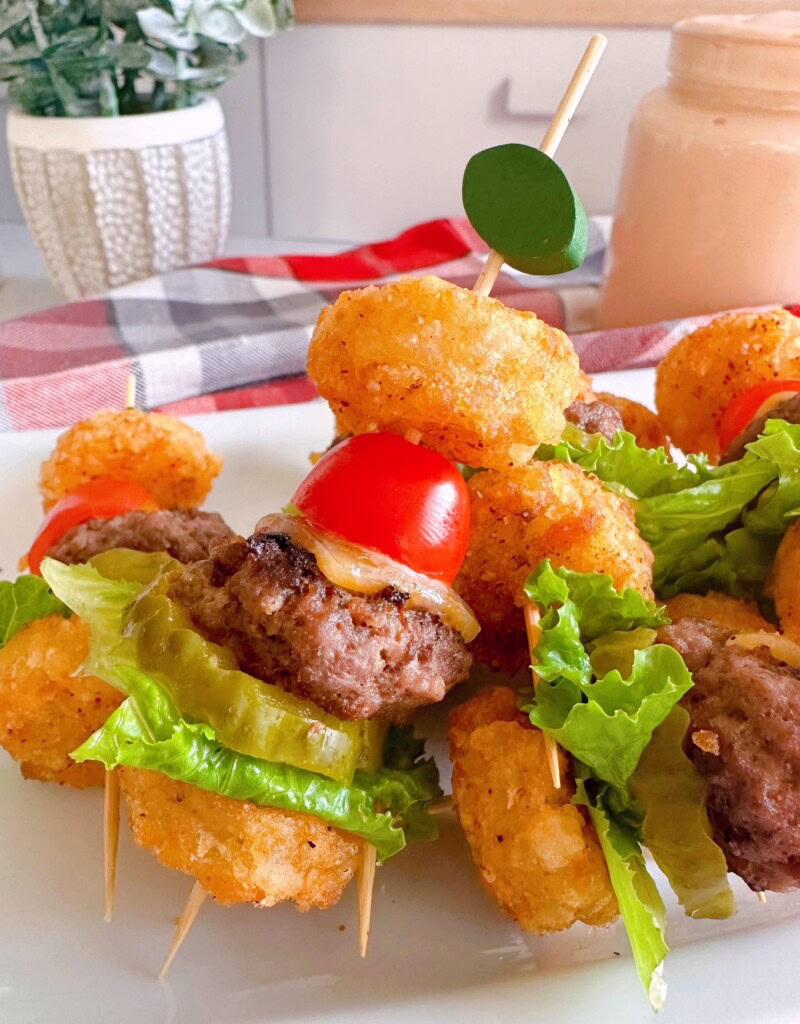 Cheeseburger mini bites on a football skewer upclose ready to serve.