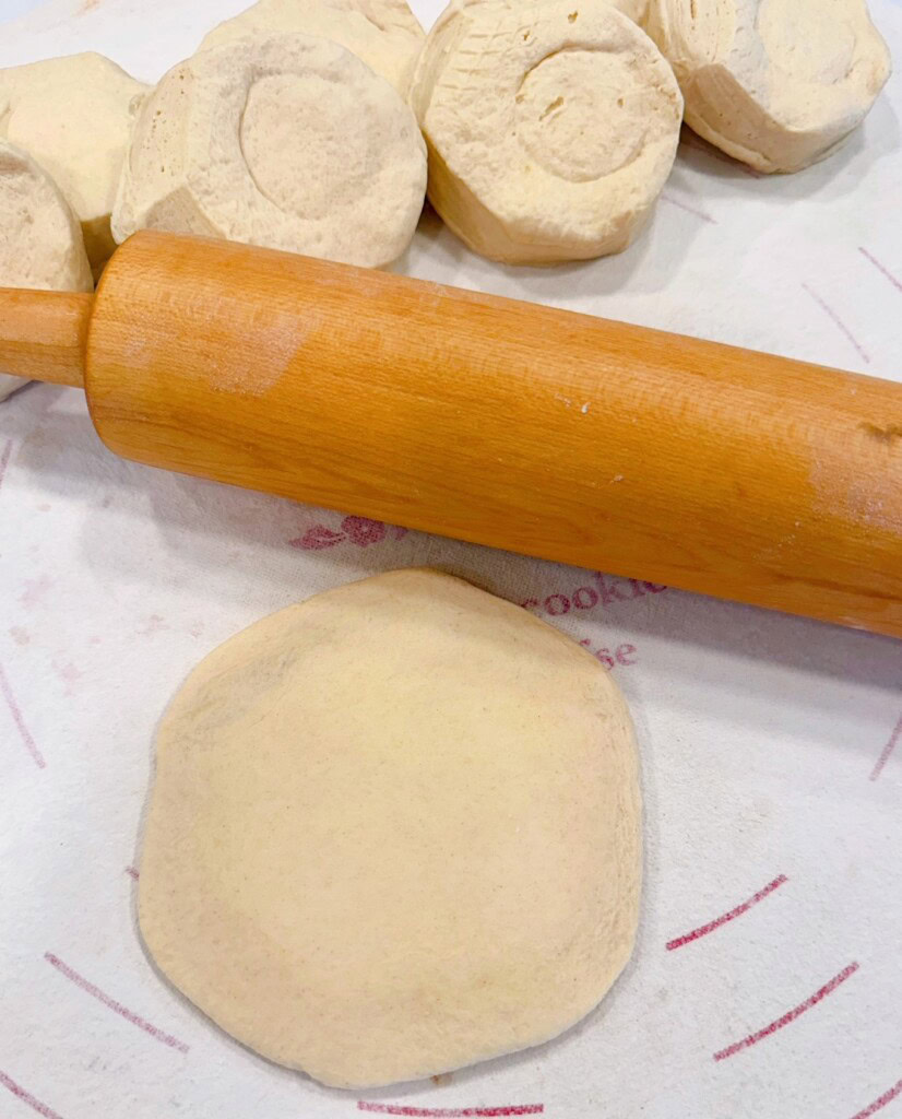 Rolling Biscuit dough into 4-5 inch circles.