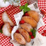 Fried Biscuit Hand Pies in a basket with fresh raspberries and mint.