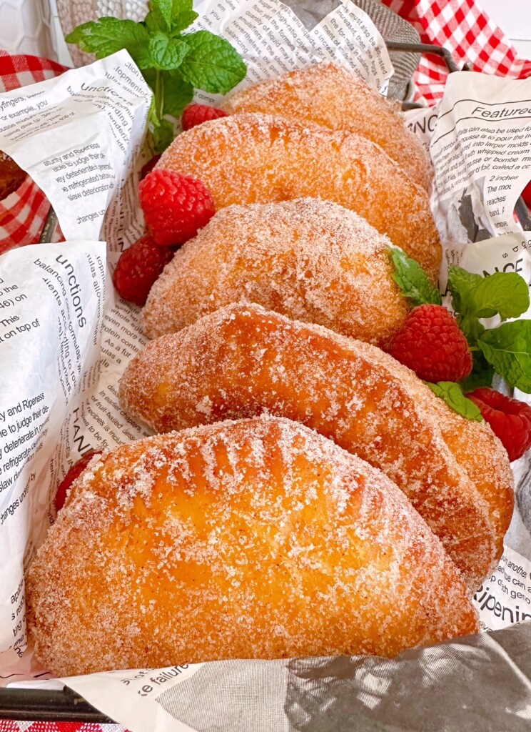 Fried Hand Pies in a basket with fresh fruit.