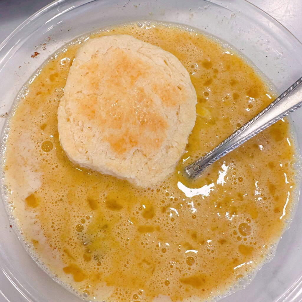 Dipping biscuits into beaten egg mixture.