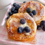 Biscuit French Toast with syrup, butter, and fresh blueberries.