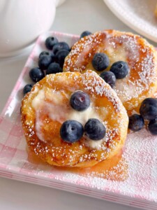 Biscuit French Toast with syrup, butter, and fresh blueberries.