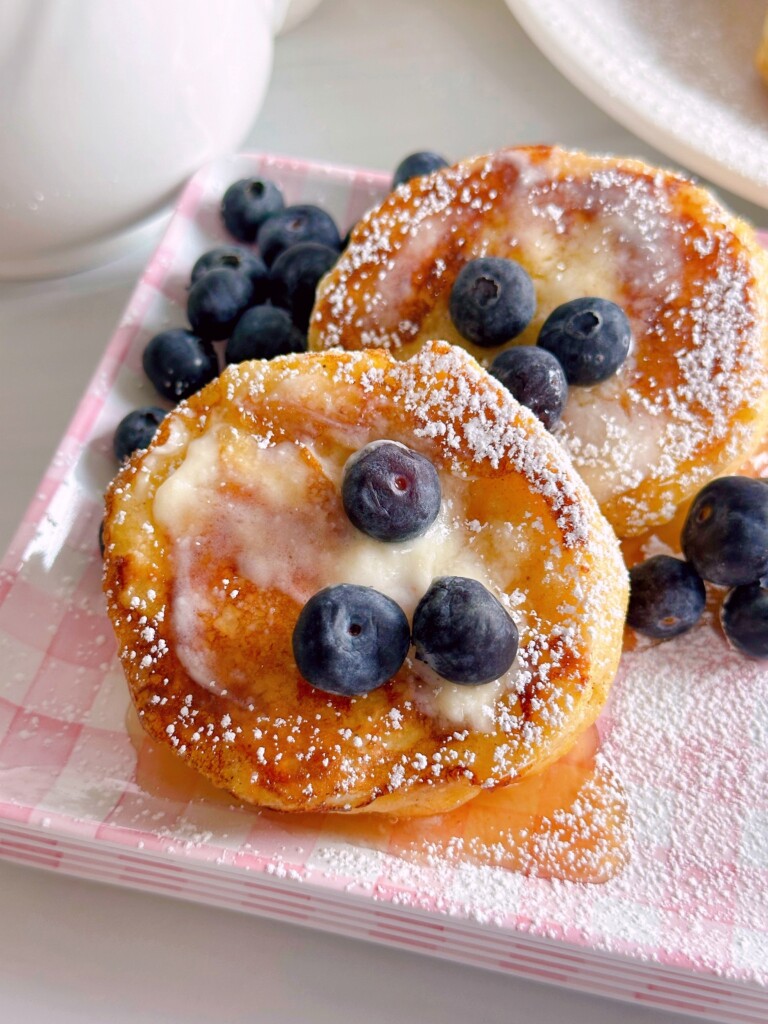 Biscuit French Toast with syrup, butter, and fresh blueberries.