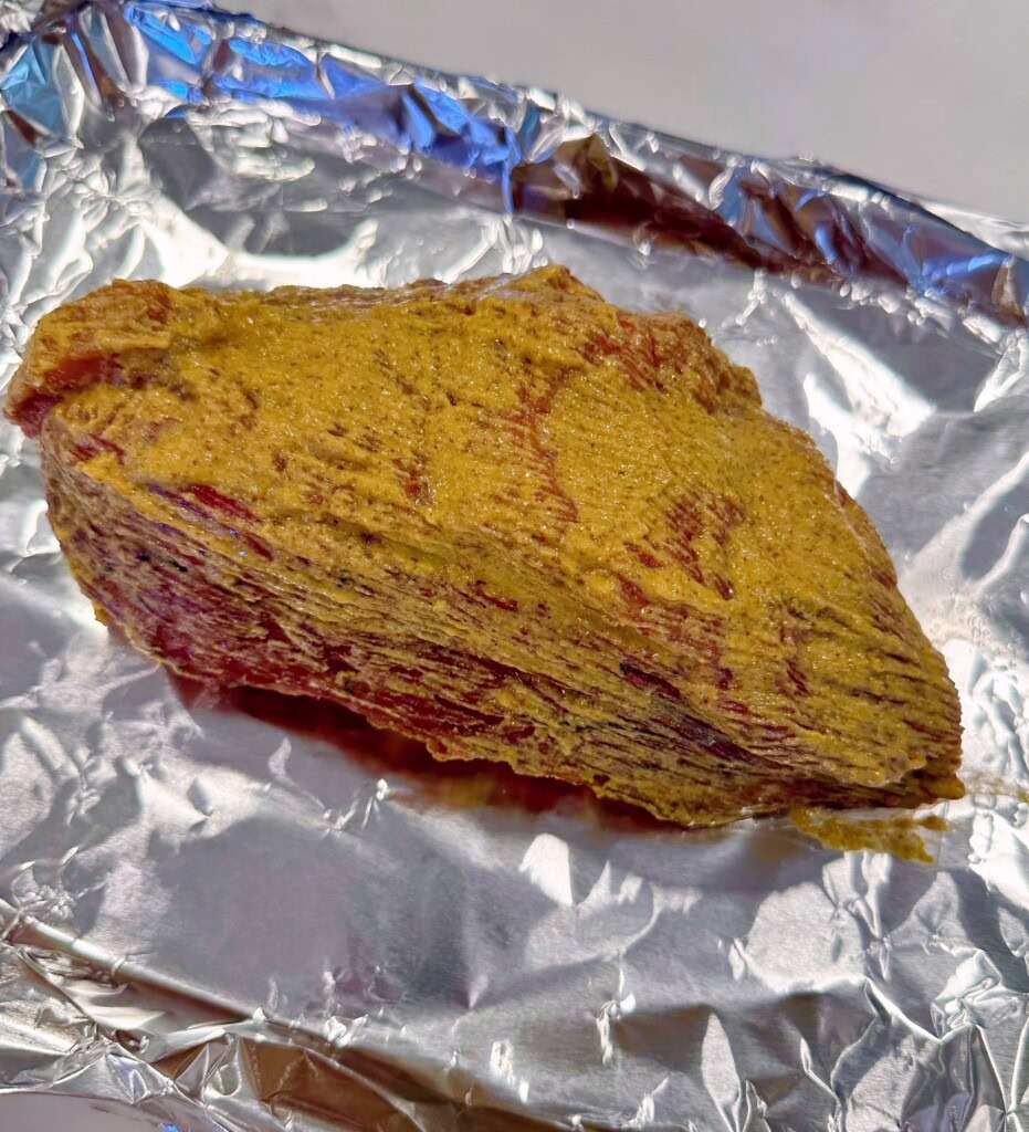 Browned Corned beef on a baking sheet.