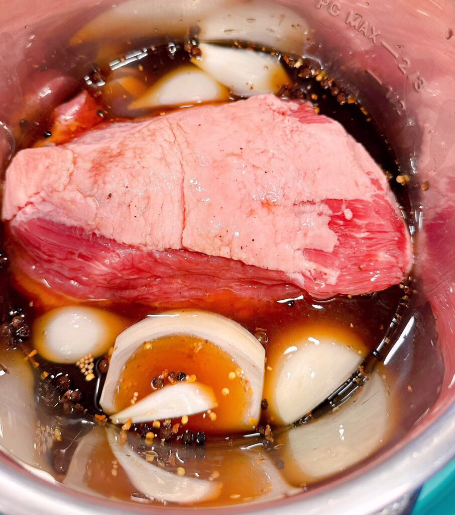Adding Beef broth to Corned Beef in the instant pot.