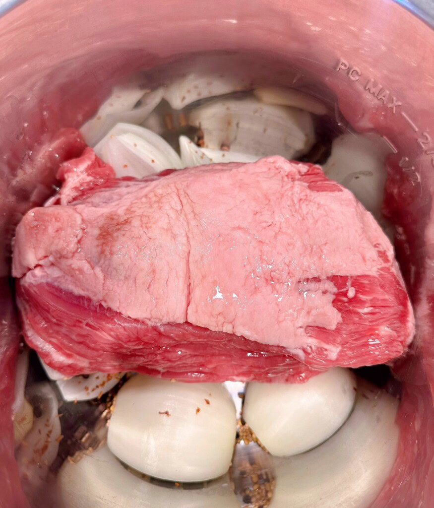 Corned Beef on top of the onions and seasoning.