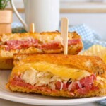 Rueben Sandwich cut and stacked on a plate.