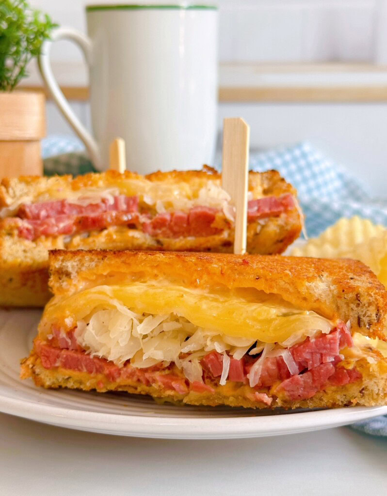 Rueben Sandwich cut and stacked on a plate.