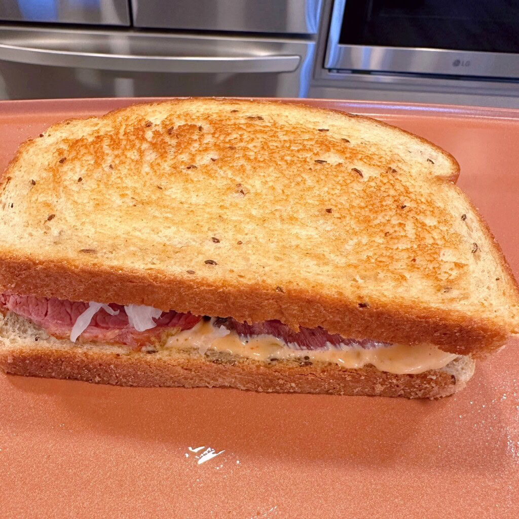 Sandwich on the griddle toasting.