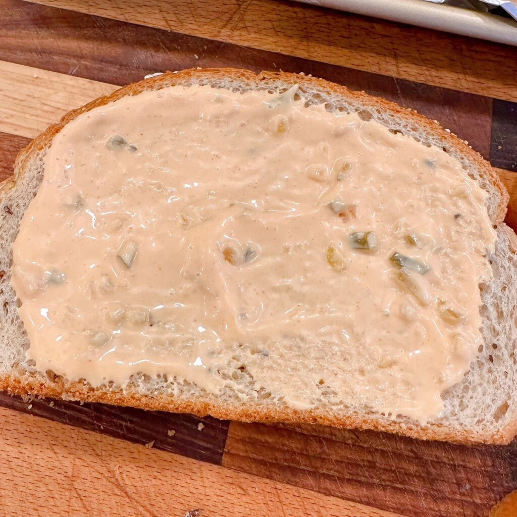 Slice of bread spread with thousand island dressing.