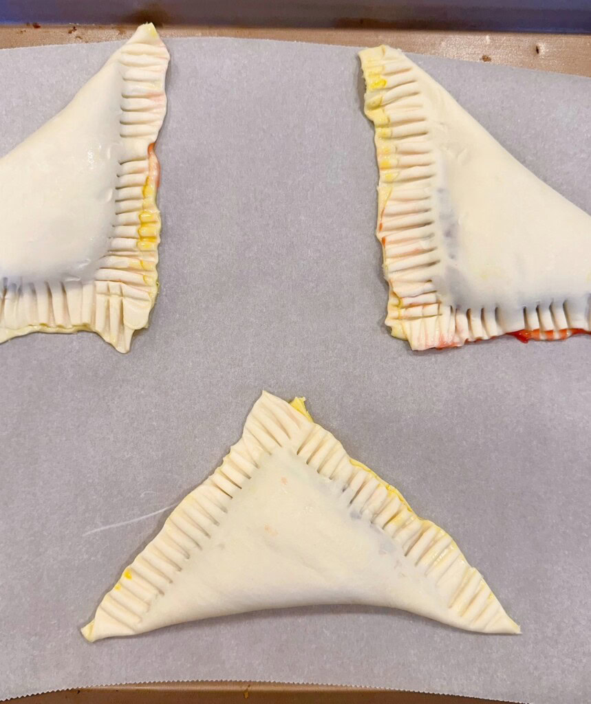 Turnovers onto parchment-lined baking sheet to bake.