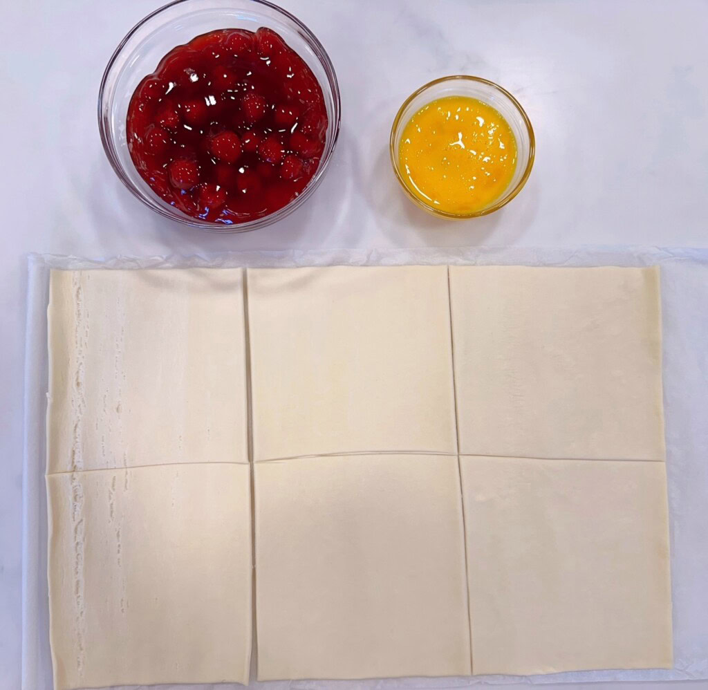 Puff pastry rolled flat and cut into 6 equal squares.