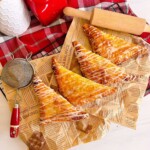Cherry Turnovers on parchment printed paper and rolling pin.