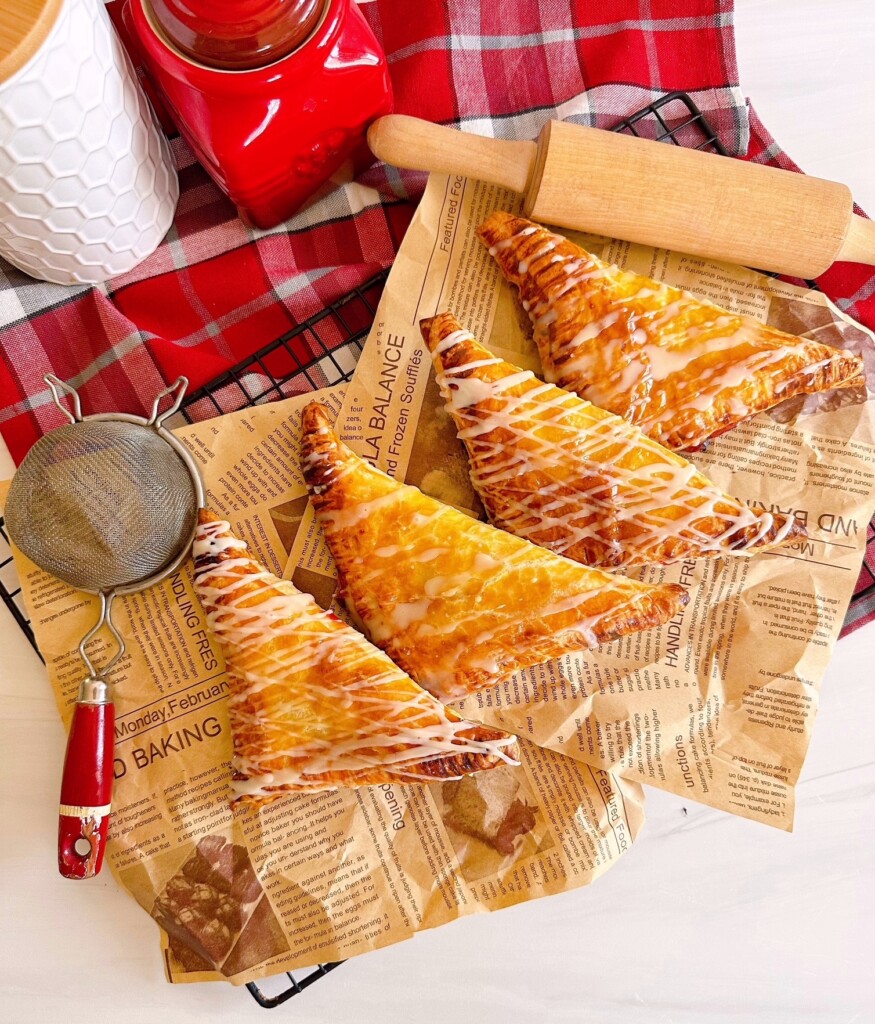 Cherry Turnovers on parchment printed paper and rolling pin.