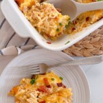 Full Serving of Chicken and Hash Brown Casserole in the casserole dish with a serving on a single plate.