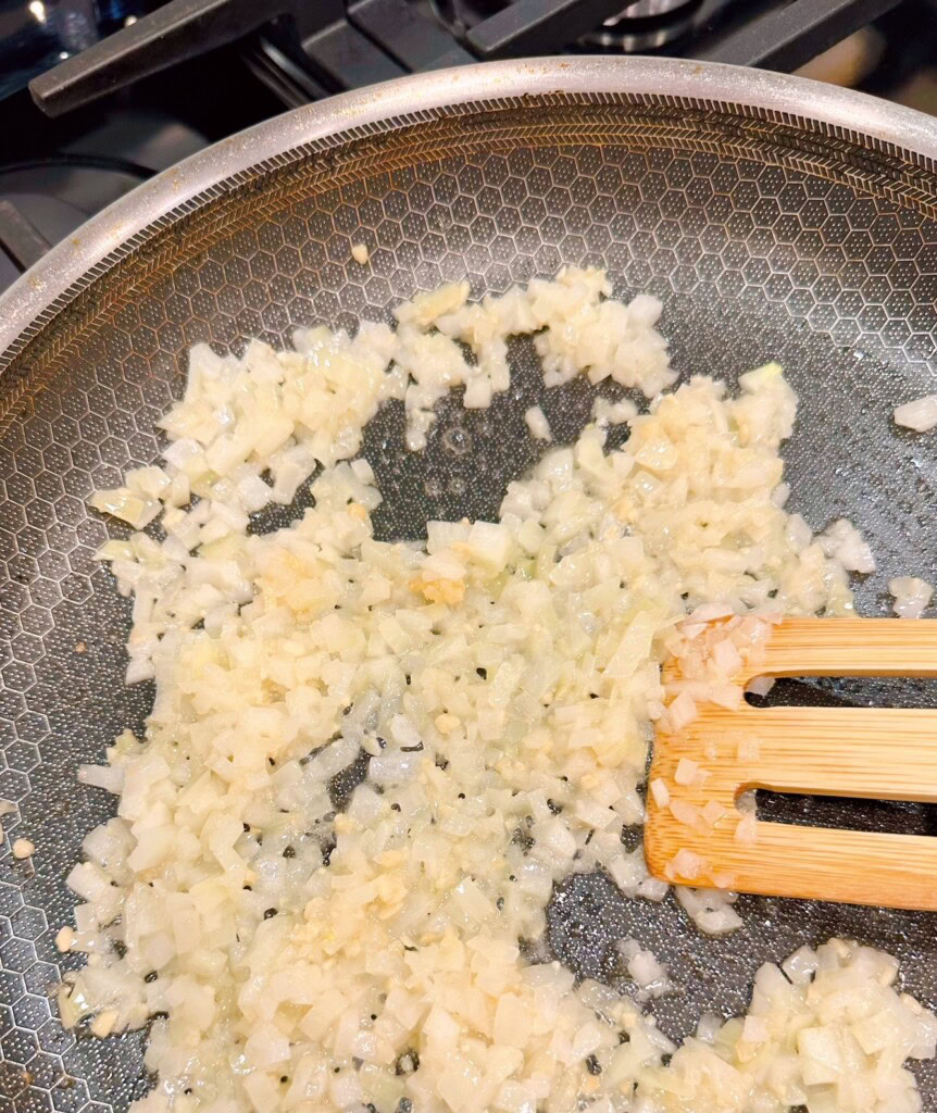 Sauting onions and garlic in a medium skillet over medium-high heat.