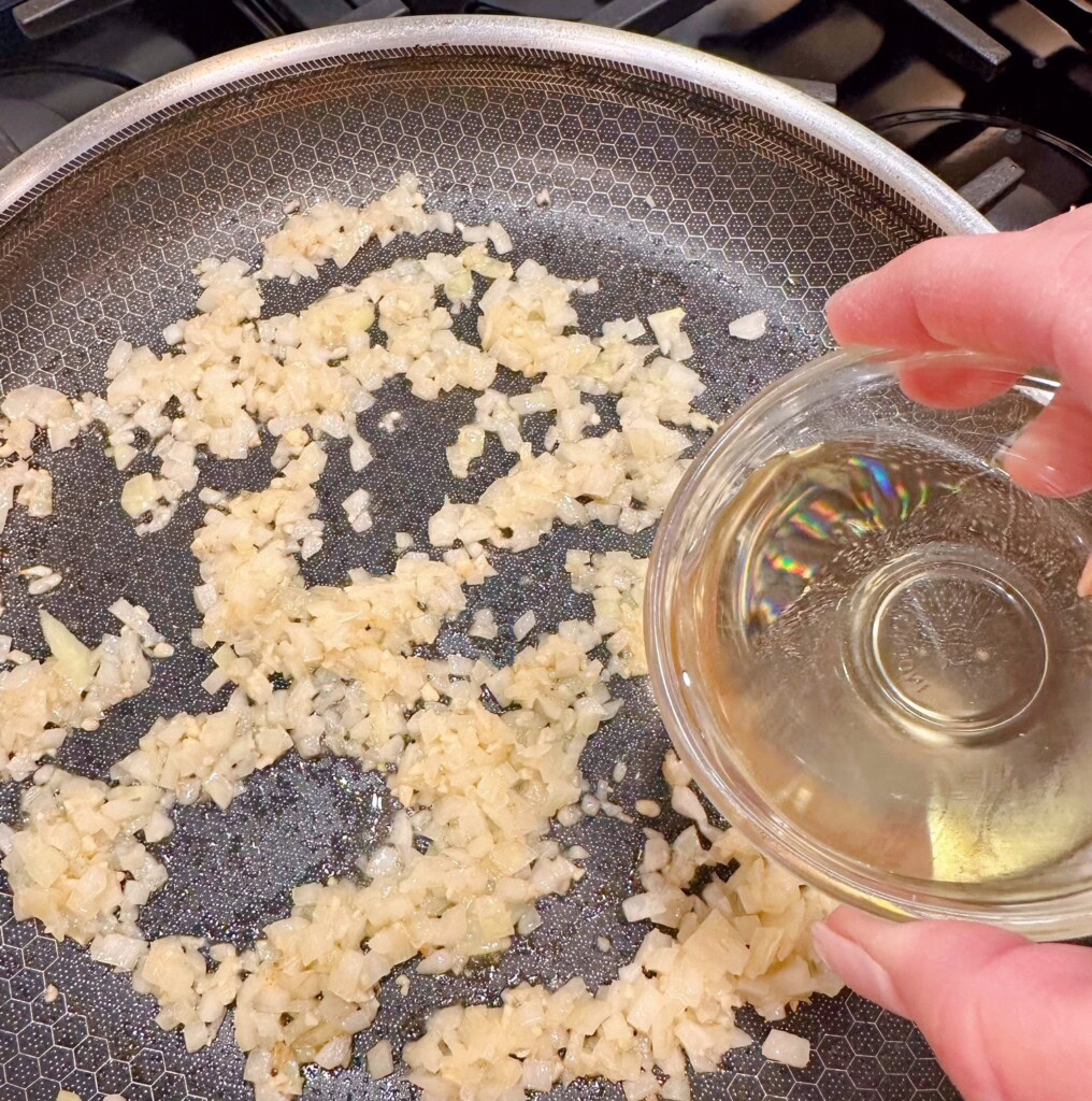 Add vegetable oil to onions and garlic.