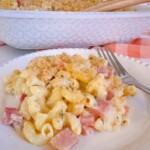 Ham and Noodle Casserole serving on a white dinner plate with a fork.