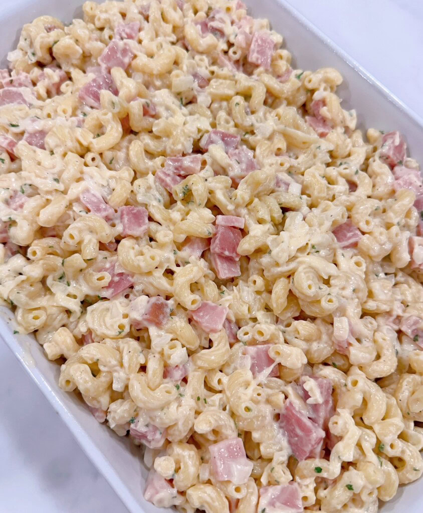 Spreading casserole in prepared baking dish.