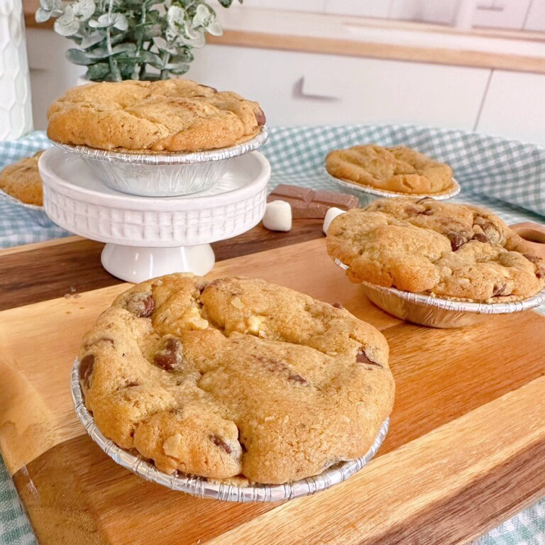 Mini S'more Chocolate Chip Pies on a small cutting board and cake stand.